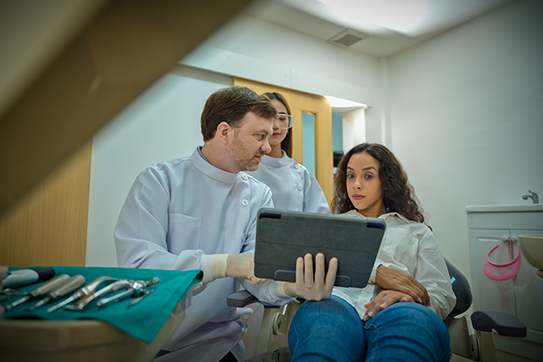 Cosmetic Dentist explaining findings to patient