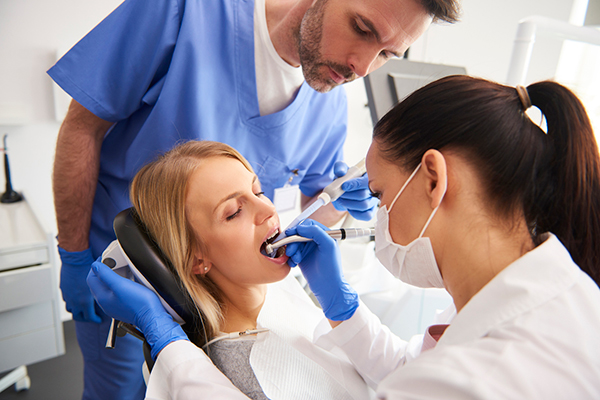 patient undergoing a dental procedure as part of a full-mouth restoration