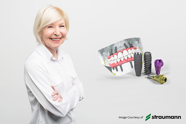 adult woman smiling with Straumann logo and dental implants