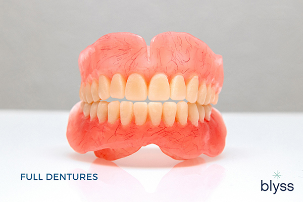 full mouth dentures placed on white surface