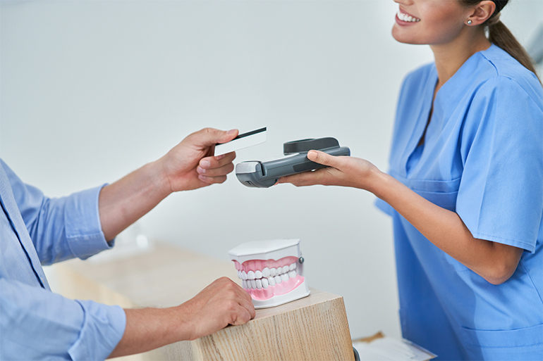 patient paying for dental treatment in a clinic using credit card